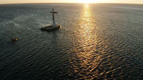 Large crucafix marking the underwater sunken cemetary, camiguin island philippines.