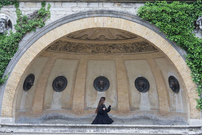 Low angle view of woman walking in historic building