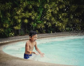 Full length of shirtless boy in swimming pool