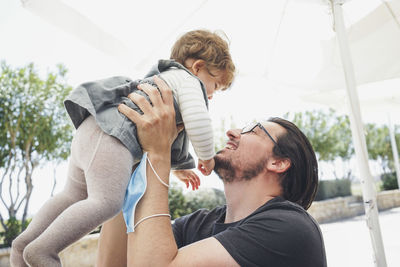 Young couple holding father