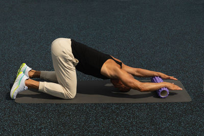 Low section of woman doing yoga