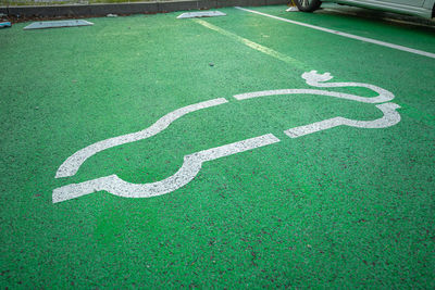 High angle view of arrow sign on road
