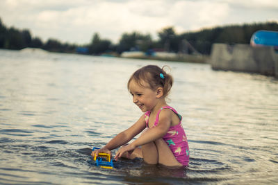 Portrait of cute girl playing in water