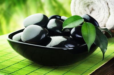 Close-up of black coffee and leaves on table