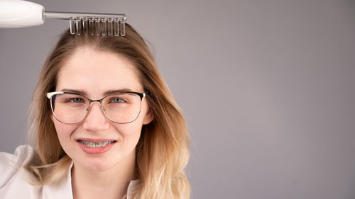 Portrait of young woman against white background