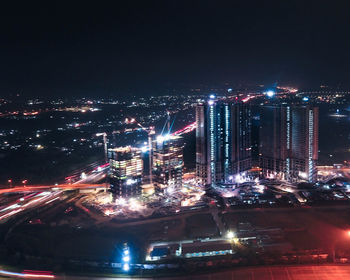 High angle view of illuminated buildings in city at night