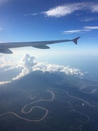 Cropped image of airplane wing over landscape