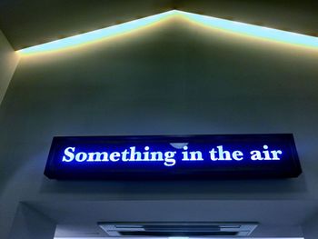 Low angle view of illuminated information sign