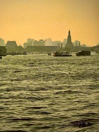 Scenic view of sea and buildings against clear sky