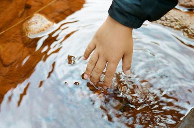 High angle view of woman hands on water