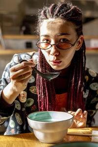 Portrait of young woman having coffee