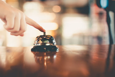 Close-up of person holding ice cream on table