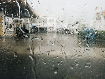 Full frame shot of wet glass window in rainy season