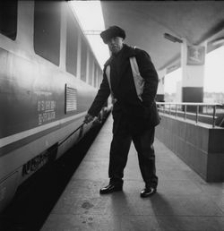 Full length of man standing at railroad station