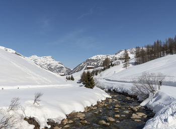 Scenic view of snow covered mountains against sky