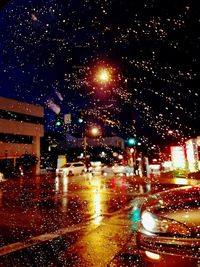 Illuminated city street during rainy season at night