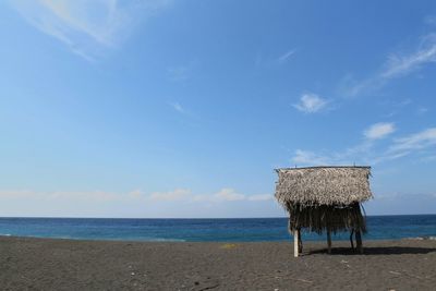 Lifeguard hut on beach against sky