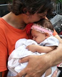 Midsection of father holding daughter