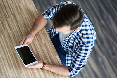 High angle view of man using mobile phone