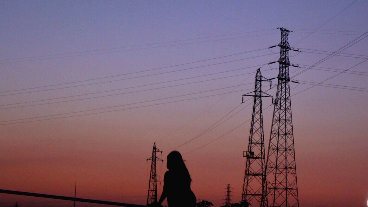 silhouette, power line, sunset, technology, electricity pylon, low angle view, connection, power supply, sky, electricity, cable, men, lifestyles, clear sky, leisure activity, orange color, dusk, outdoors