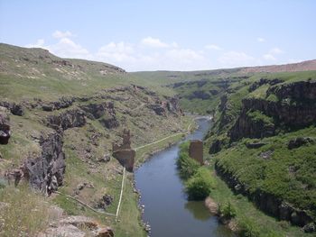 Scenic view of river amidst trees against sky