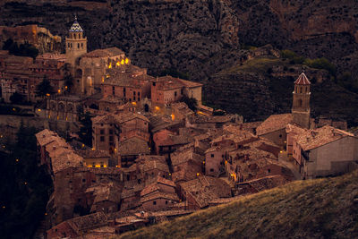 High angle view of illuminated buildings in city at night