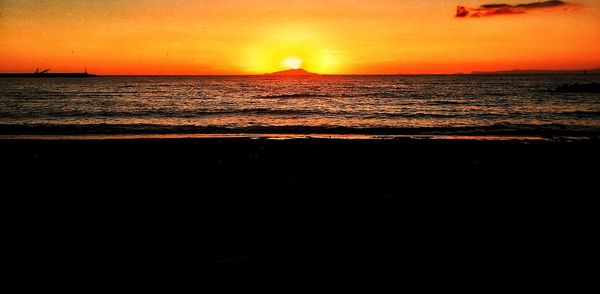 Scenic view of sea against orange sky