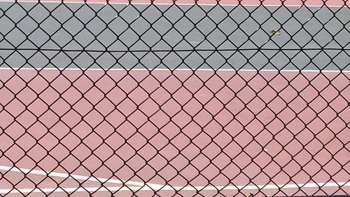 Full frame shot of chainlink fence against sky