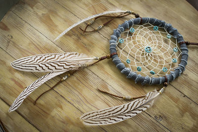 High angle view of dreamcatcher on wooden table