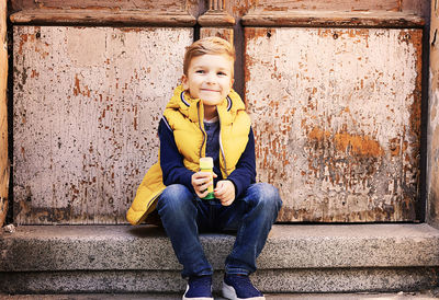 Portrait of boy sitting outdoors