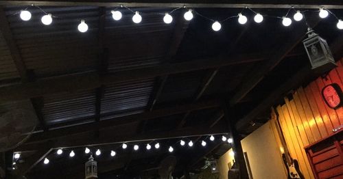 Low angle view of illuminated lights at night