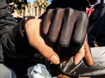 People holding hands showing interracial