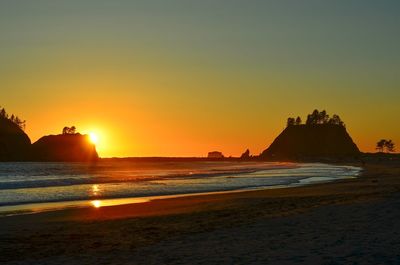 Scenic view of sea against clear sky during sunset