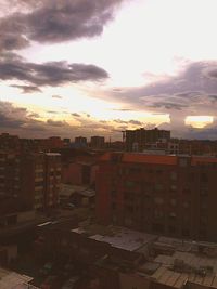 High angle view of cityscape against cloudy sky