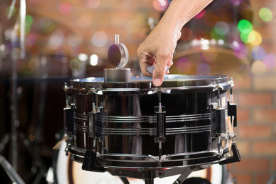 Cropped hand of man holding musical instrument