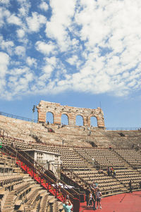 Amphitheatre historic building against blue cloudy sky