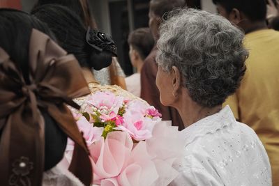 Rear view of woman holding flower bouquet