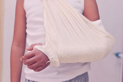 Midsection of woman with broken hand