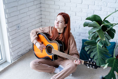 Young woman playing guitar