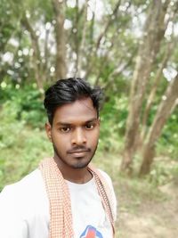 Portrait of young man in forest