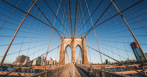 View of suspension bridge against cloudy sky