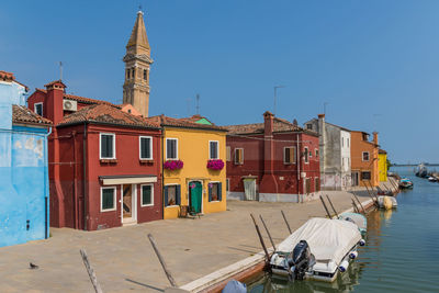 View of buildings against clear blue sky