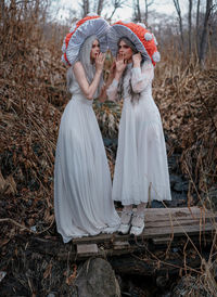 Full length of women standing in forest