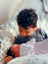 High angle view of cute baby sleeping on bed