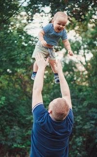 Father and son playing on tree