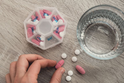 Cropped hand of woman holding pills