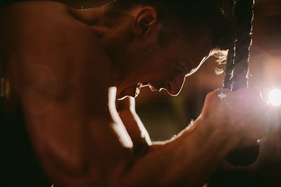 Shirtless man exercising at home