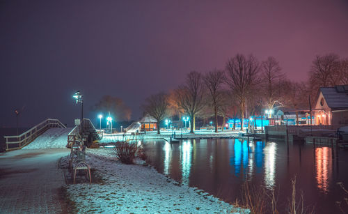 Illuminated city at night during winter