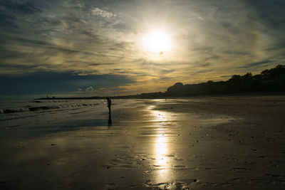 Scenic view of beach against sky during sunset