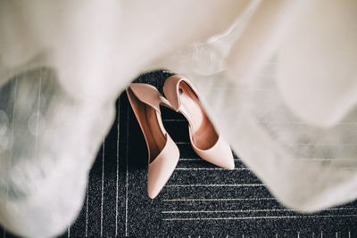 Close-up of dress and high heels on floor